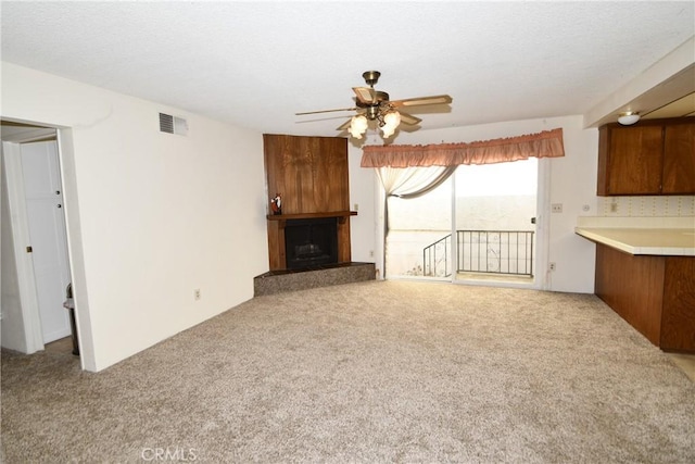 unfurnished living room with light carpet and ceiling fan