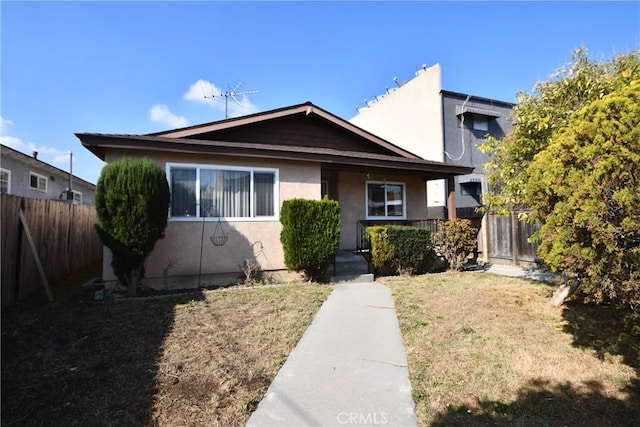 bungalow-style home featuring a front yard