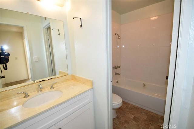 full bathroom with bathtub / shower combination, vanity, and toilet