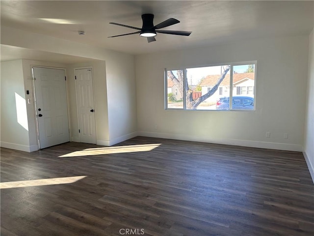 spare room with dark hardwood / wood-style flooring and ceiling fan