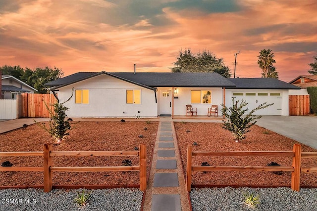 ranch-style house with a garage and covered porch