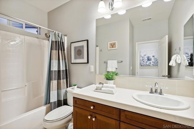 full bathroom featuring vanity, toilet, and shower / tub combo