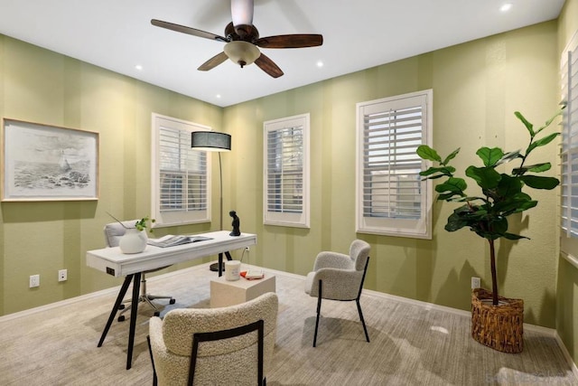 office space featuring light colored carpet and ceiling fan