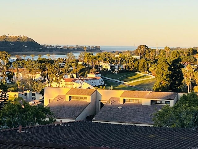 aerial view at dusk featuring a water view