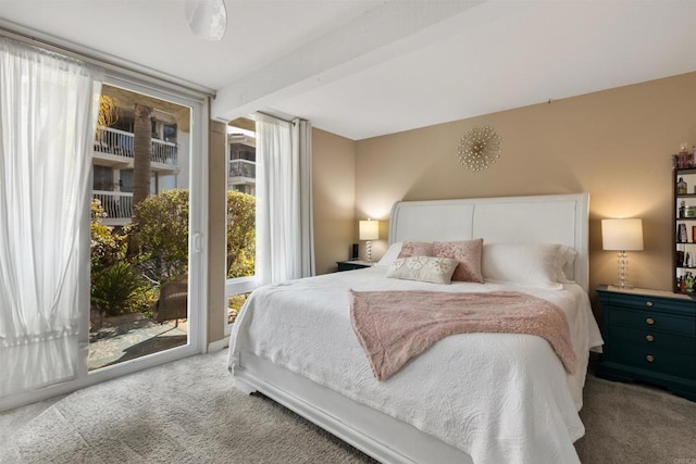 carpeted bedroom featuring access to outside, beam ceiling, and floor to ceiling windows