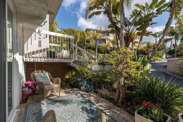 balcony featuring stairs and a patio area