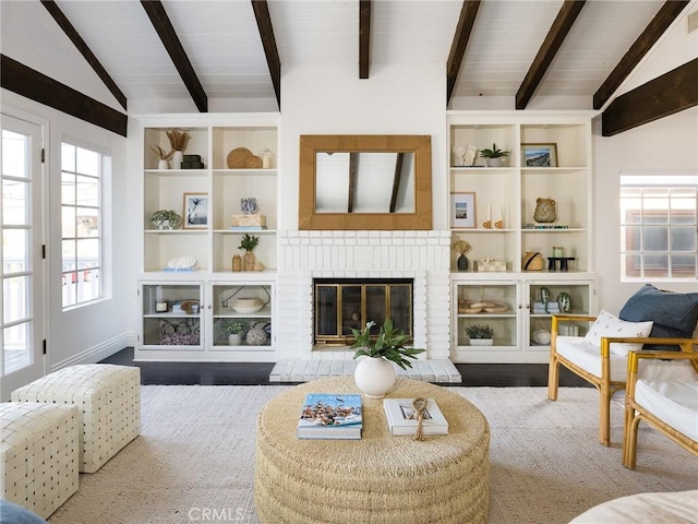 living room featuring wood-type flooring, a brick fireplace, and vaulted ceiling with beams