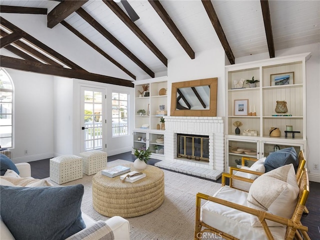 living room with wood-type flooring, vaulted ceiling with beams, and a fireplace