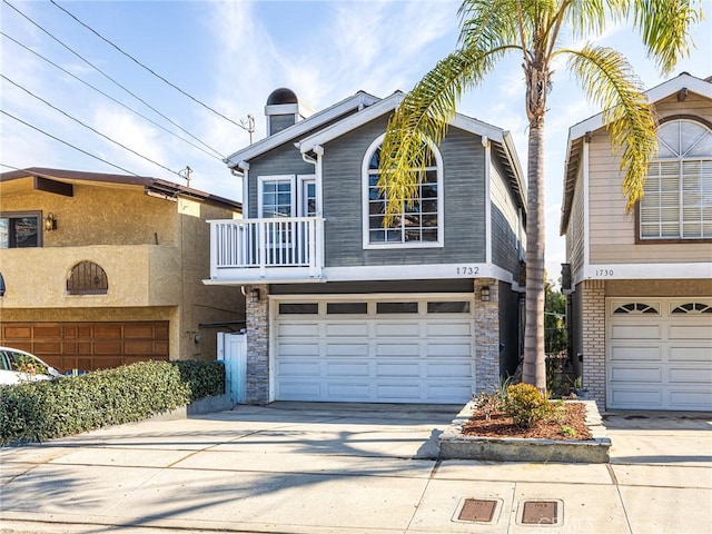 view of front of home featuring a garage and a balcony