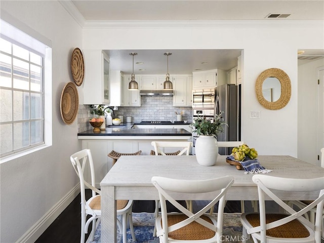 dining room with breakfast area and ornamental molding