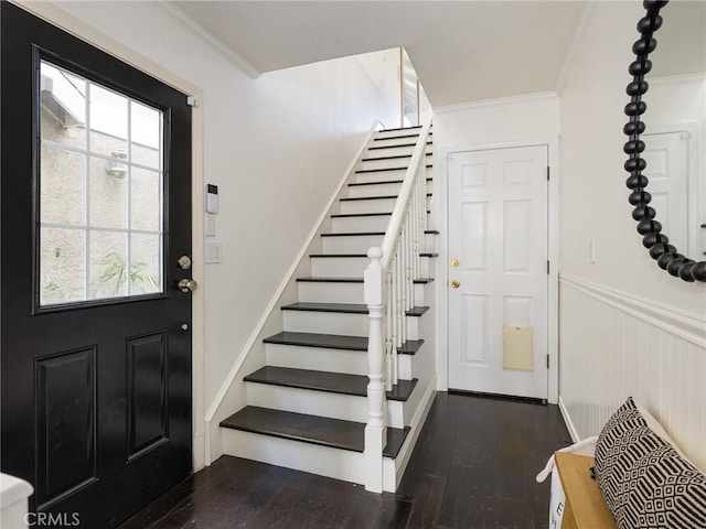 entrance foyer featuring ornamental molding and dark wood-type flooring