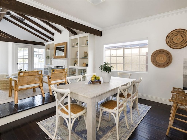 dining room with lofted ceiling with beams, crown molding, dark hardwood / wood-style floors, and a fireplace