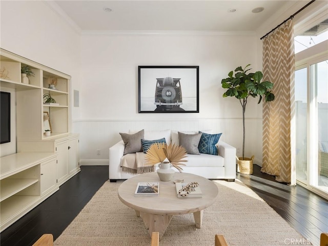 living room featuring ornamental molding and dark hardwood / wood-style flooring