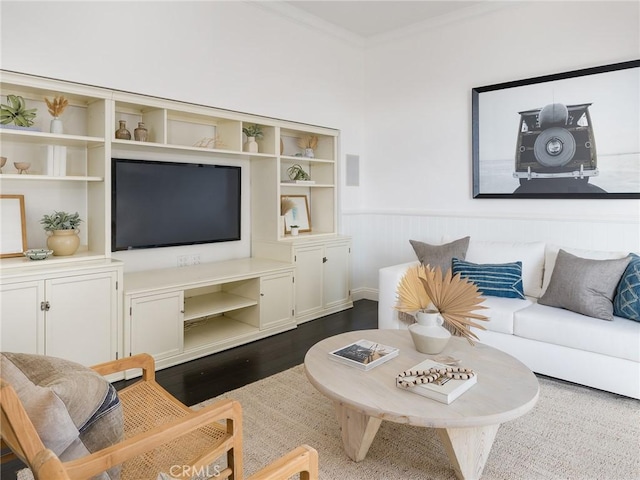 living room with dark hardwood / wood-style flooring and crown molding