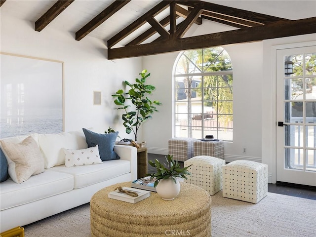 living room with hardwood / wood-style floors, lofted ceiling with beams, and a healthy amount of sunlight