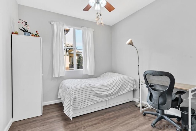 bedroom with ceiling fan and dark hardwood / wood-style flooring