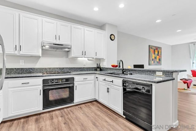 kitchen with sink, kitchen peninsula, white cabinets, and black appliances