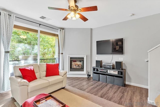 living room featuring hardwood / wood-style flooring and ceiling fan