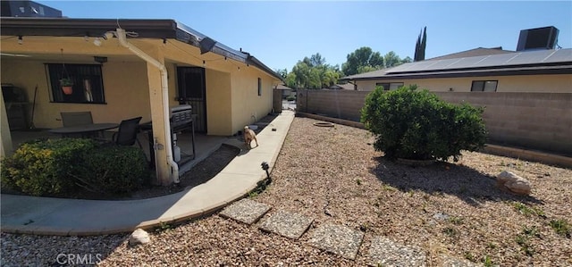 view of side of home with solar panels