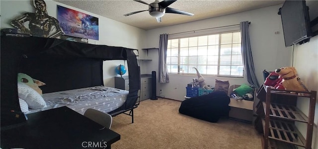 carpeted bedroom with ceiling fan and a textured ceiling