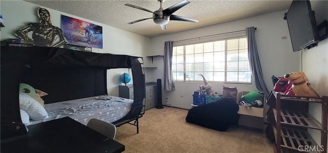 bedroom featuring light colored carpet, a textured ceiling, and ceiling fan