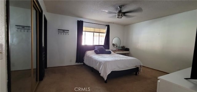 carpeted bedroom featuring a textured ceiling and ceiling fan