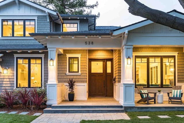 rear view of property featuring a porch