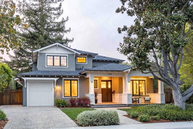 view of front of home featuring a garage and a porch