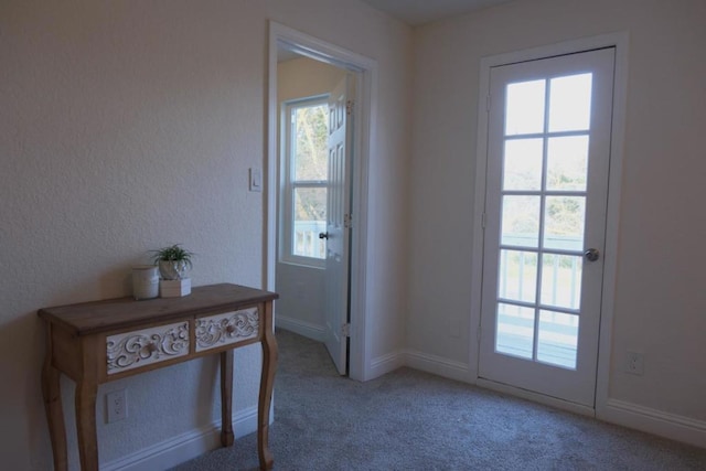 doorway with light colored carpet