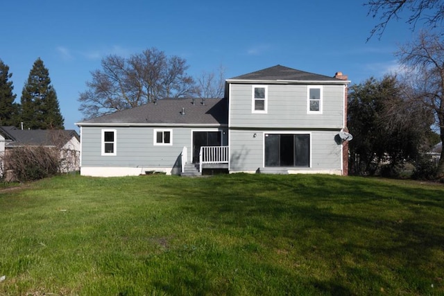 back of house featuring a lawn