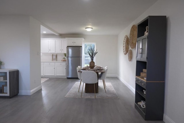 dining area featuring dark wood-type flooring