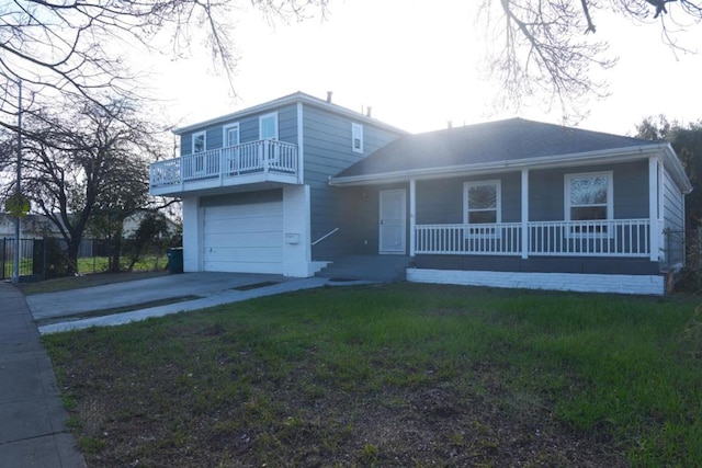 view of front of home with a garage, a front yard, and a porch