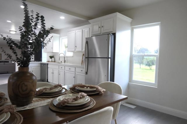 kitchen featuring sink, dark wood-type flooring, stainless steel appliances, and white cabinets