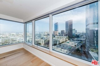 unfurnished room featuring hardwood / wood-style flooring and a healthy amount of sunlight