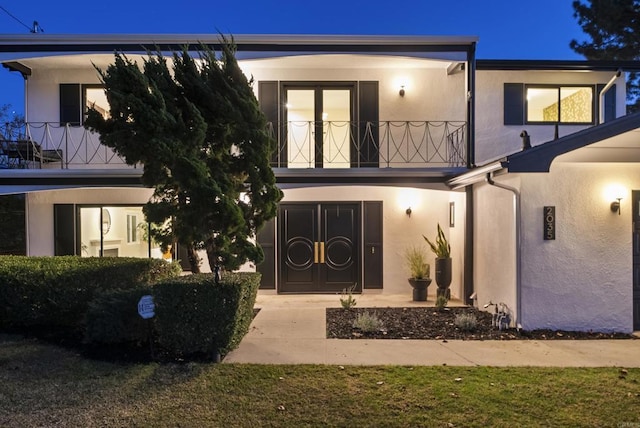 exterior space featuring a front yard and a balcony