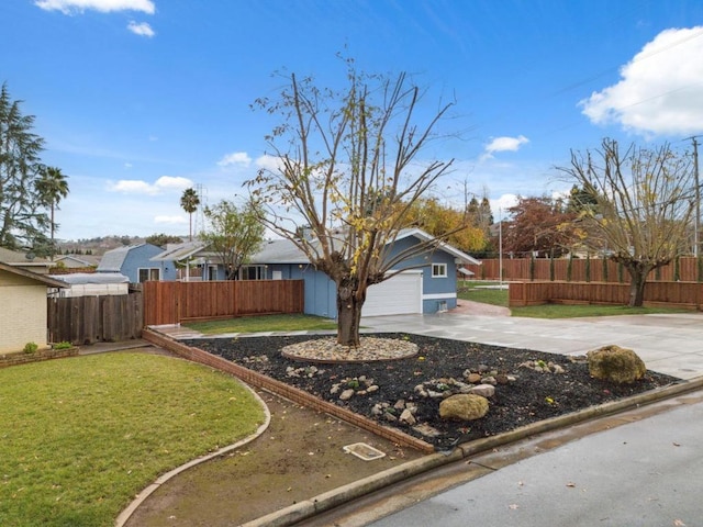 view of front of property with a garage and a front lawn