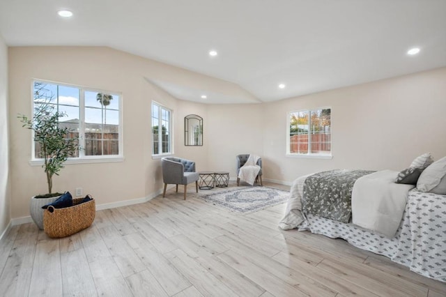 bedroom with lofted ceiling and light hardwood / wood-style flooring