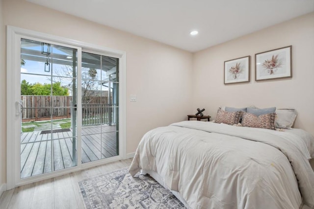 bedroom with access to exterior and light hardwood / wood-style flooring