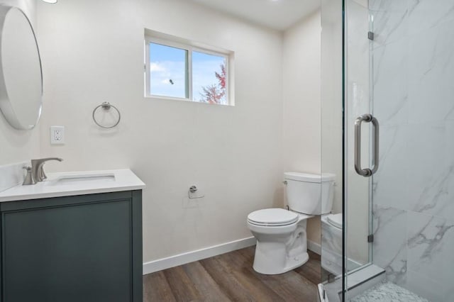 bathroom with vanity, hardwood / wood-style floors, toilet, and walk in shower