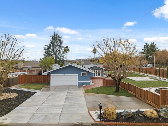 view of front of property with a garage and a front lawn