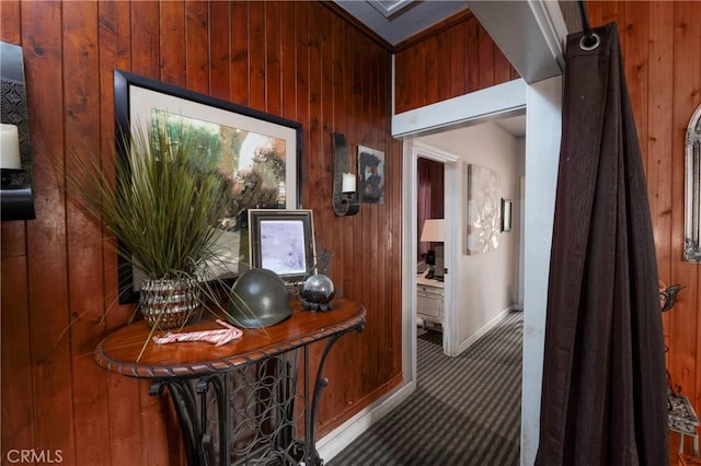 corridor with wooden walls and carpet floors