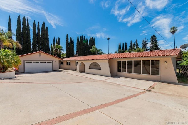 view of front facade featuring a garage and an outdoor structure