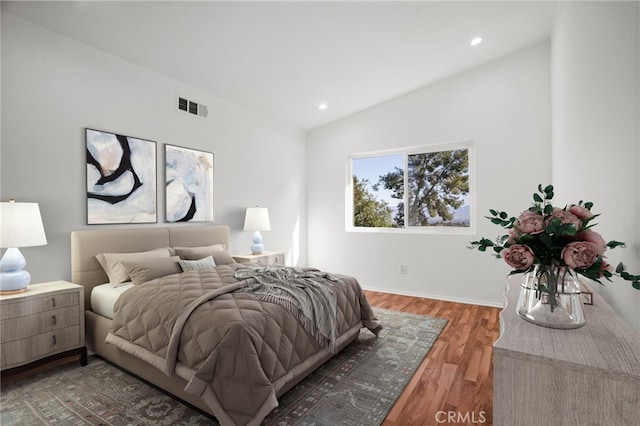 bedroom featuring lofted ceiling, visible vents, dark wood-style flooring, and recessed lighting