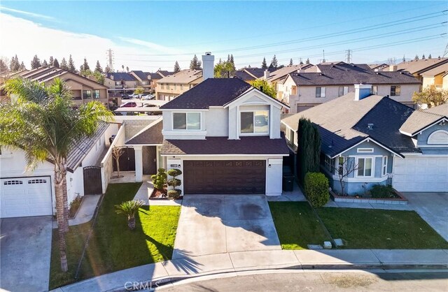 view of front of home featuring a garage and a front yard