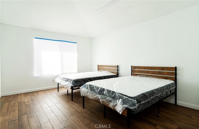 bedroom featuring dark wood-type flooring