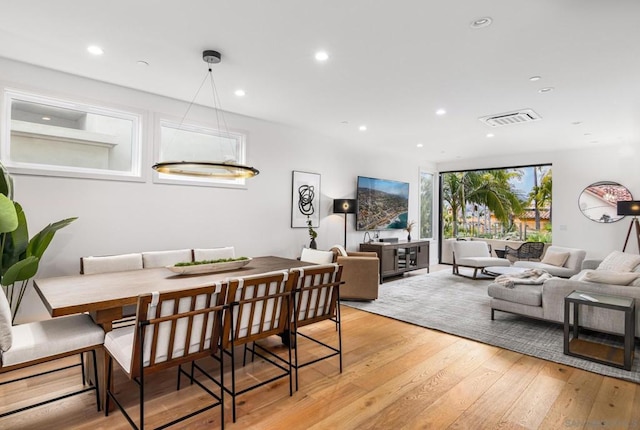 dining room featuring light hardwood / wood-style flooring and expansive windows