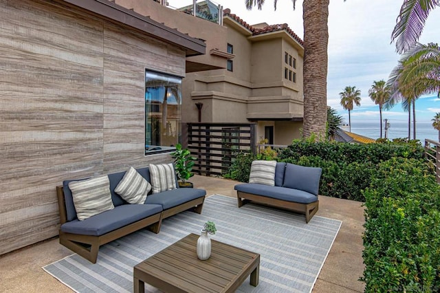 view of patio with an outdoor living space and a water view