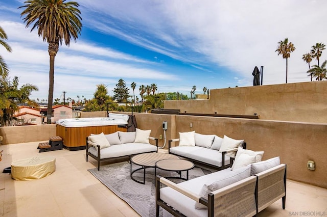 view of patio / terrace featuring a hot tub and an outdoor hangout area