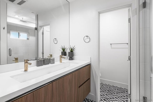 bathroom featuring vanity, tile patterned floors, and walk in shower