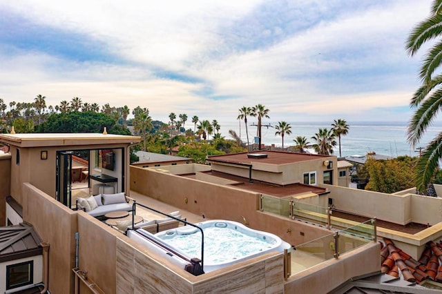 exterior space with an outdoor hot tub